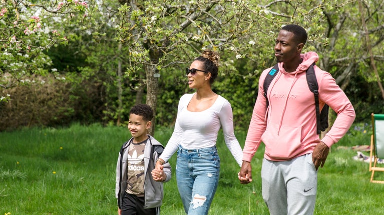 A family in the orchard during the Festival of Blossom at Quarry Bank, Cheshire